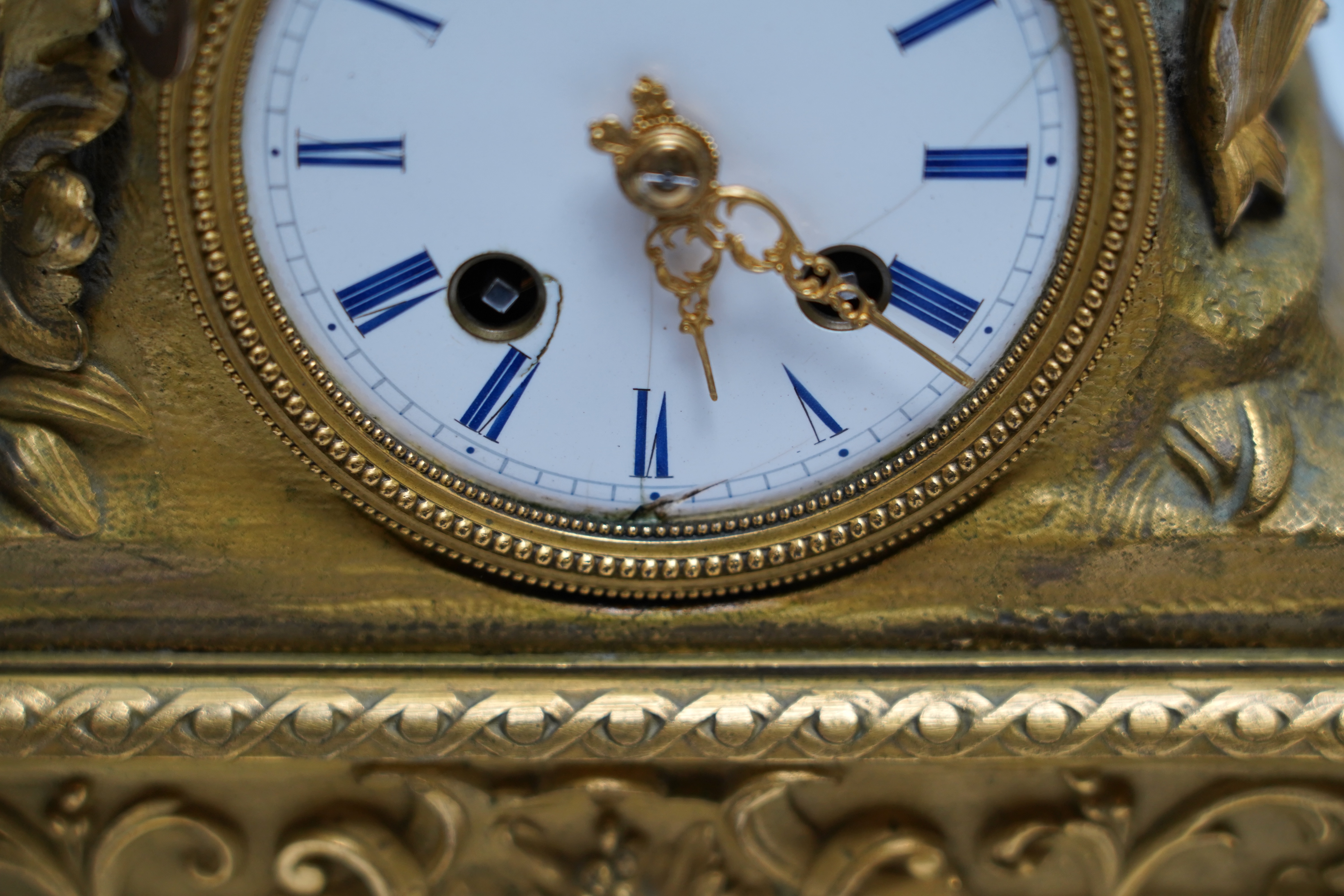 A mid 19th century French ormolu figural mounted clock with silk suspension, with key, 36cm